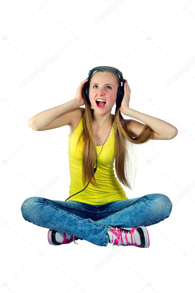 girl in headphones listens to music and laughs