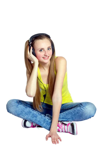 Girl in headphones listens to music and laughs — Stock Photo, Image