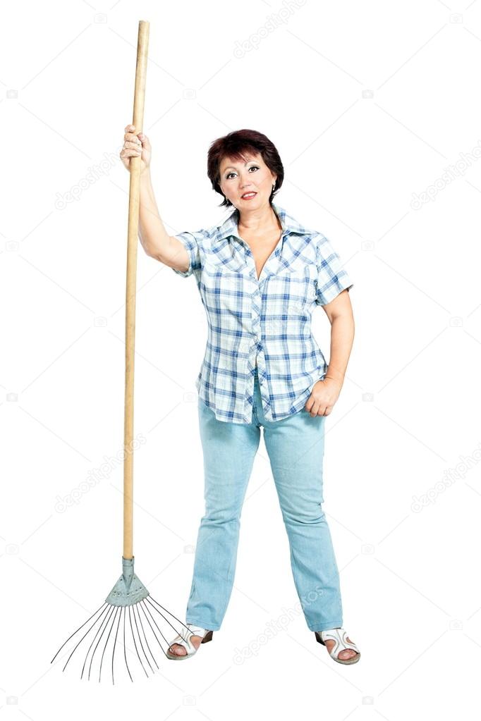 Image of woman farmer with rakes in hands