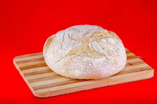 Loaf of bread on a wooden board — Stock Photo, Image