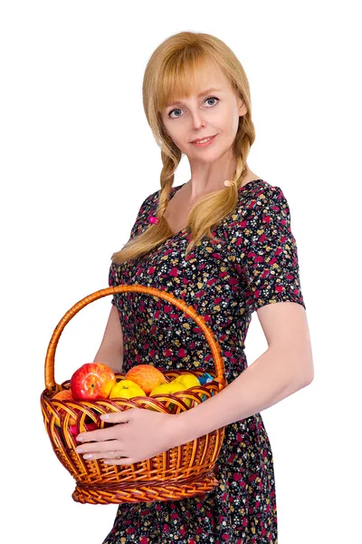 Blonde girl with a basket of ripe apples — Stock Photo, Image