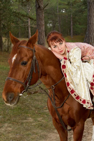 Beautiful girl in antique dress on horseback — Stock Photo, Image