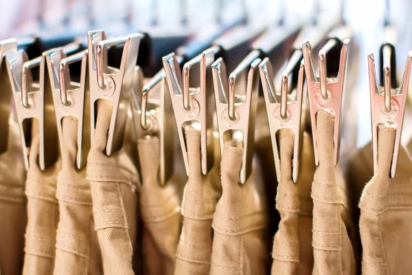 Jeans iron clothespins hanging in the closet — Stock Photo, Image