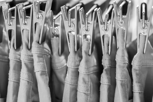 Jeans iron clothespins hanging in the closet — Stock Photo, Image