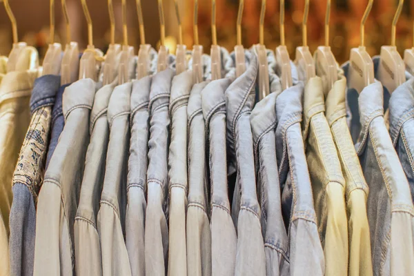 Denim shirt hanging on a hanger in the store — Stock Photo, Image