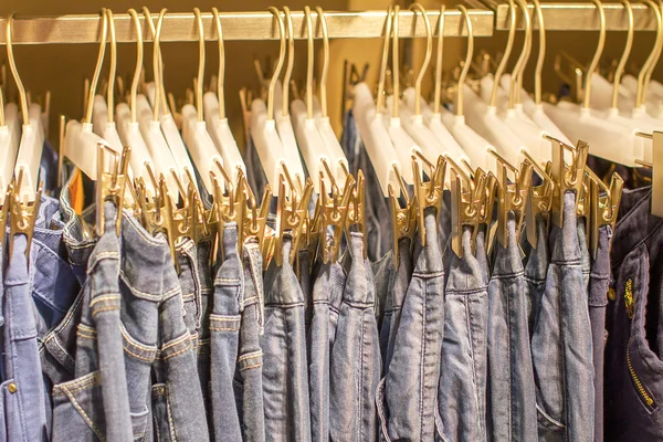 Preview jeans hanging on a hanger in the store — Stock Photo, Image