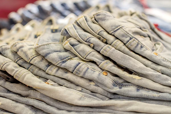 Stack of folded jeans in the store — Stock Photo, Image