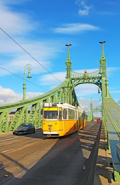 Orange tram on the Liberty bridge in Budapest, Hungary — Stock Photo, Image