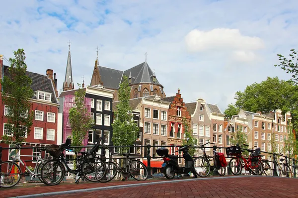 Amsterdam cityscape with bikes on the bridge — Stock Photo, Image