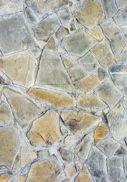 Фон стены с серыми и желтыми камнями . — стоковое фото