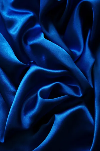 Soepele elegante blauwe zijde achtergrond — Stockfoto