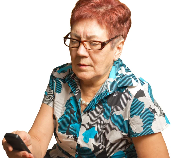 An elderly woman is calling on a cell phone, isolated. — Stock Photo, Image