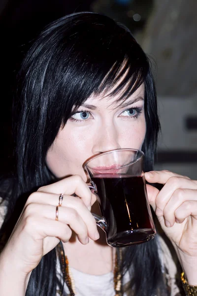 Beautiful lady drinks mulled wine — Stock Photo, Image