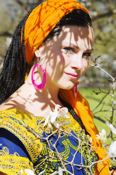 Beautiful blue-eyed woman with the african pigtails — Stock Photo, Image