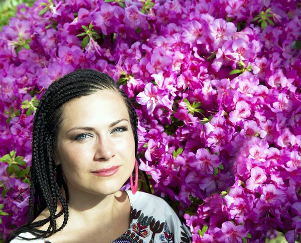 Beautiful blue-eyed woman with the african pigtails — Stock Photo, Image