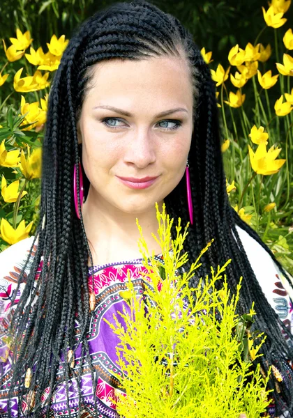 Beautiful blue-eyed woman with the african pigtails — Stock Photo, Image