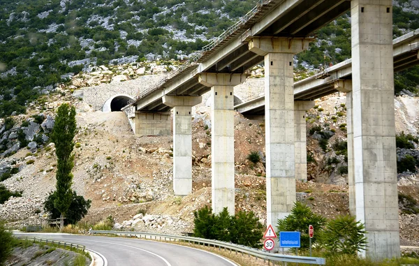 A bridge on piles going away to the tunnel — Stock Photo, Image