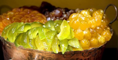 Luxurious candied fruit are in the pastry shops clipart