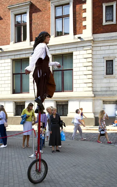 Acrobat doing tricks on unicycle — Stock Photo, Image