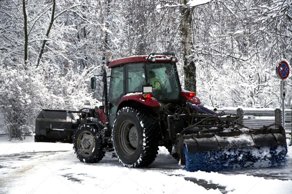 Snow cleaning tractor clears paths