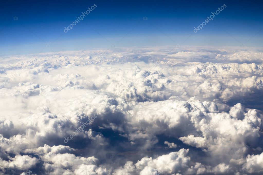 Blue sky and puffy clouds on height of 5000 m