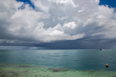 Papeete Adası yakınlarındaki Pasifik Okyanusu üzerinde yağmur bulutları. Deniz doğası kavramının üzerine bulutlar yağar.