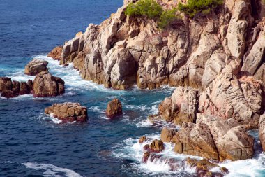 Mediterranean sea with rocky coast in Lloret de Mar located in popular Costa Brava, Catalonia, Spain. Amazing rock cliff seascape in the coastline.
