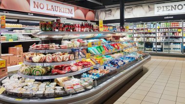 LATVIA, RIGA, JULY, 2022: Gastronomy department with a large selection of cheeses and dairy products in the RIMI hypermarket in Riga, Latvia. Retail industry. Grocery shopping. Food quality.