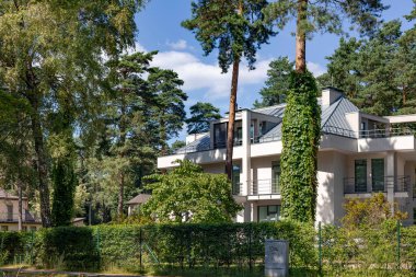 Condominium and apartment building with symmetrical modern architecture in the Mezaparks district, quiet and forest area of Riga, capital of Latvia
