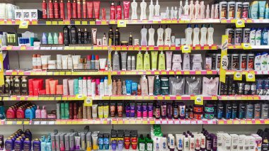 LATVIA, RIGA, AUGUST, 2022: Shelves with shampoos and conditioners with reduced prices on sale in Rimi Baltic hypermarket, Riga. Latvia. Rimi Baltic is a major retail operator in the Baltic states based in Riga, Latvia.