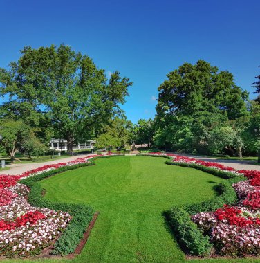 Beautiful city park with flower beds near the Latvian National Academic Opera and Ballet Theatre in Riga, capital of Latvia, EU
