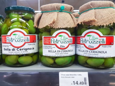 Latvia, Riga, August, 2022 - Shelves with Petruzzelli brands of high quality of green olives in shopping mall in Riga, Latvia.