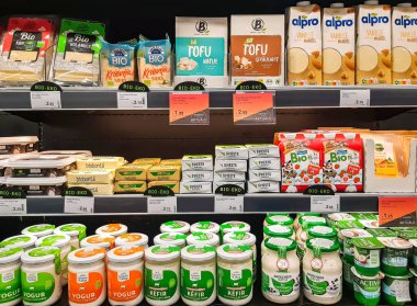 LATVIA, RIGA, AUGUST, 2022: Delicious and healthy bio dairy products on shelf of supermarket. Natural products without milk fat substitute. Food quality concept.