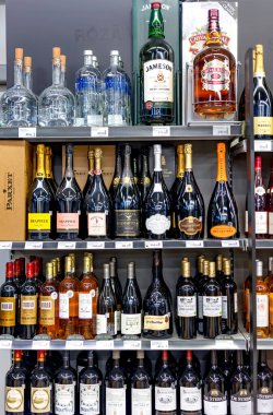 LATVIA, RIGA, AUGUST, 2022: Shelves with variety brand of high quality alcohol in the shopping mall in Riga, Latvia. Chivas Regal is a brand of Scottish Whisky, part of Pernod Ricard alcohol group.