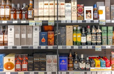 LATVIA, RIGA, AUGUST, 2022: Shelves with variety brand of high quality alcohol in the shopping mall in Riga, Latvia.