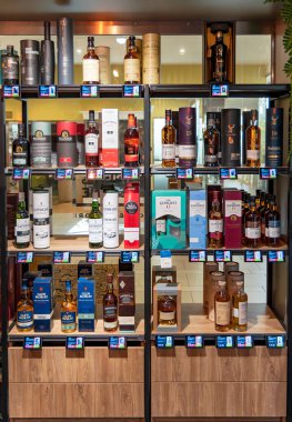 LATVIA, RIGA, AUGUST, 2022: Shelves with variety brand of high quality alcohol in the shopping mall in Riga, Latvia