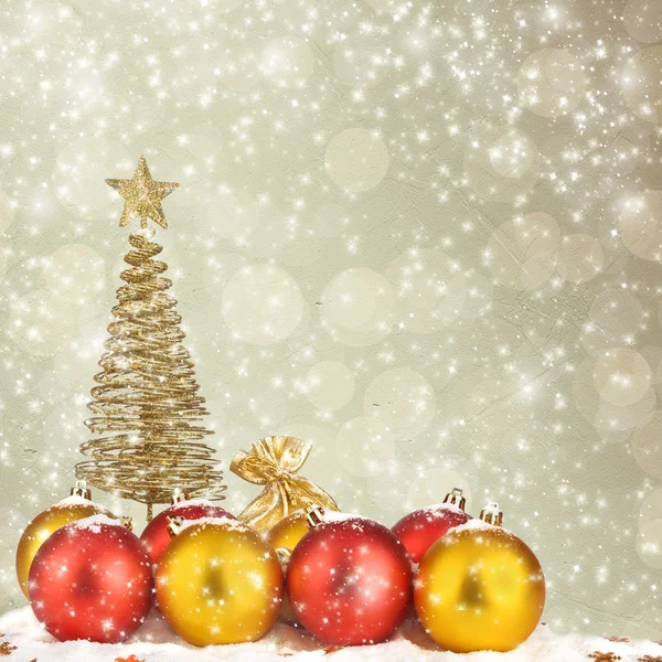 Christmas tree with balls and gift bags on snow background abstr — Stock Photo, Image