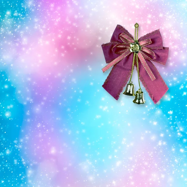 Pink Christmas bow with golden bells on an abstract background — Stock Photo, Image