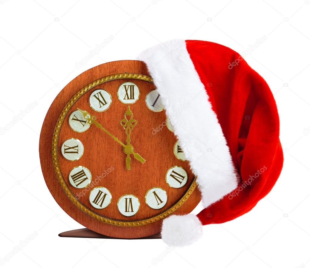 Santa Claus hat on New Year's night on the old clock showing twe