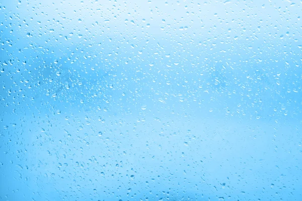 Flowing water drops on the glass in a gloomy autumn day — Stock Photo, Image