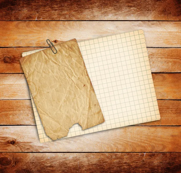 Old sheets of paper on grunge wooden background — Stock Photo, Image