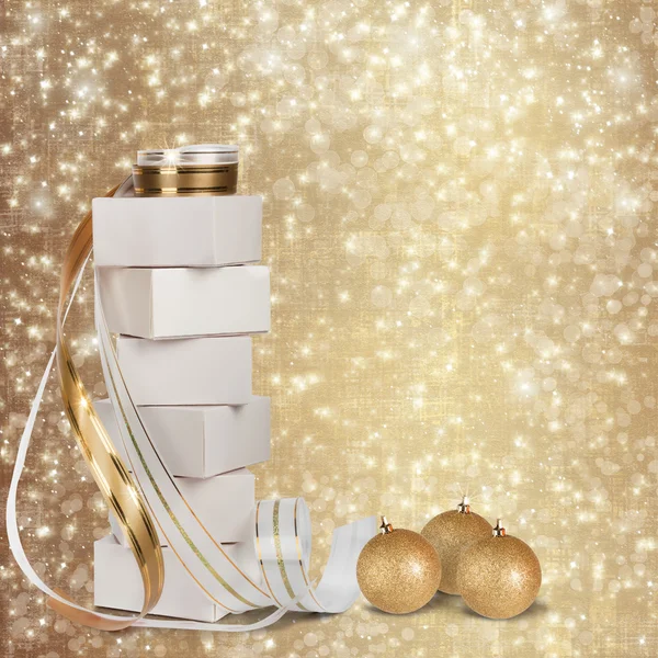 Christmas gifts and balls with gold ribbon — Stock Photo, Image