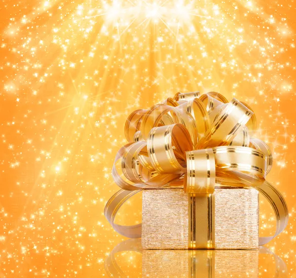 Gift box in gold wrapping paper — Stock Photo, Image