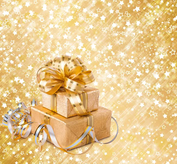 Gift box in gold wrapping paper — Stock Photo, Image