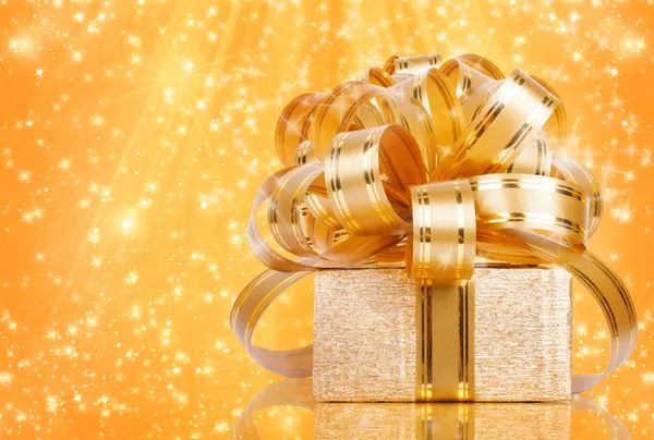 Gift box in gold wrapping paper — Stock Photo, Image