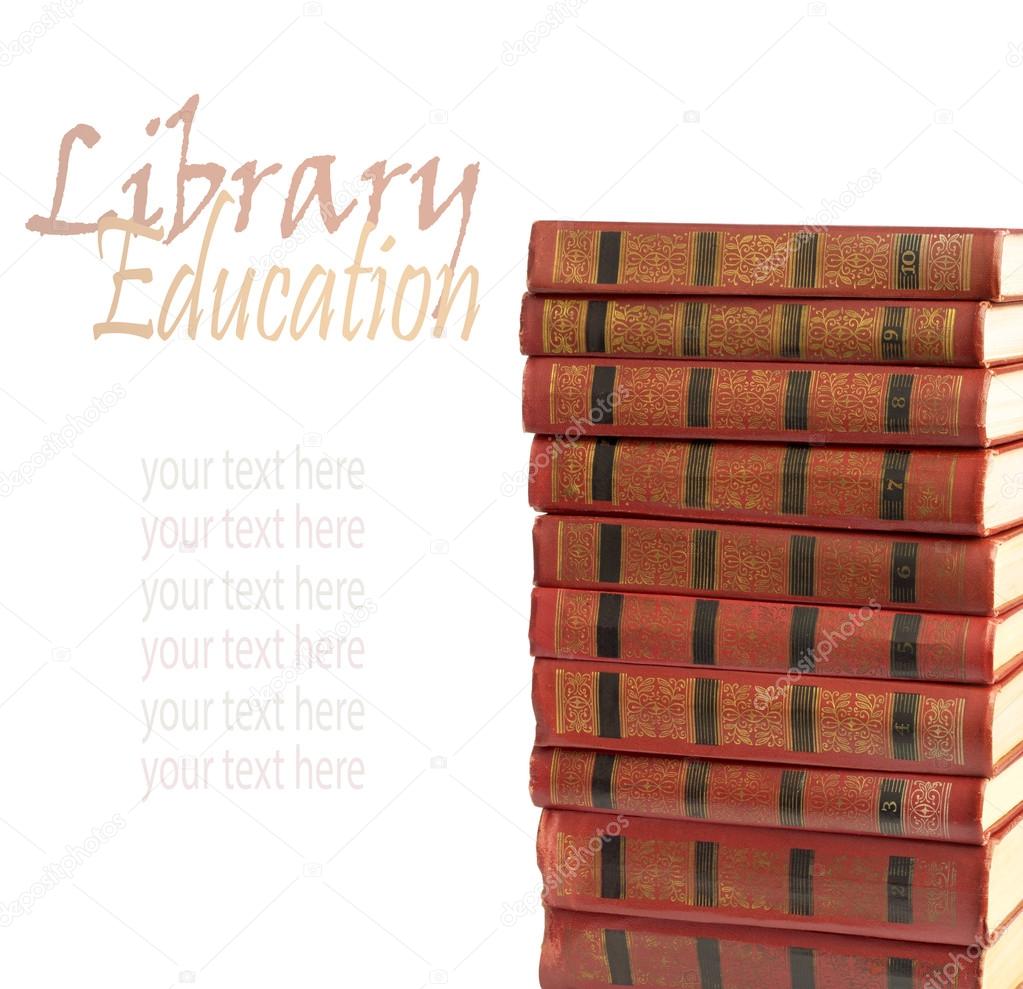 A stack of old books with gold stamping on a white background