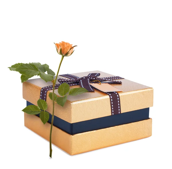 Krásný dárkový box v papírové zlato s lukem a růže — Stock fotografie