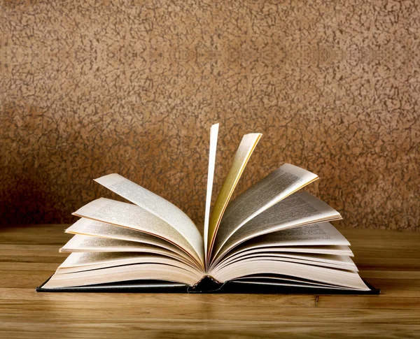 Old open book on grunge wooden table — Stock Photo, Image