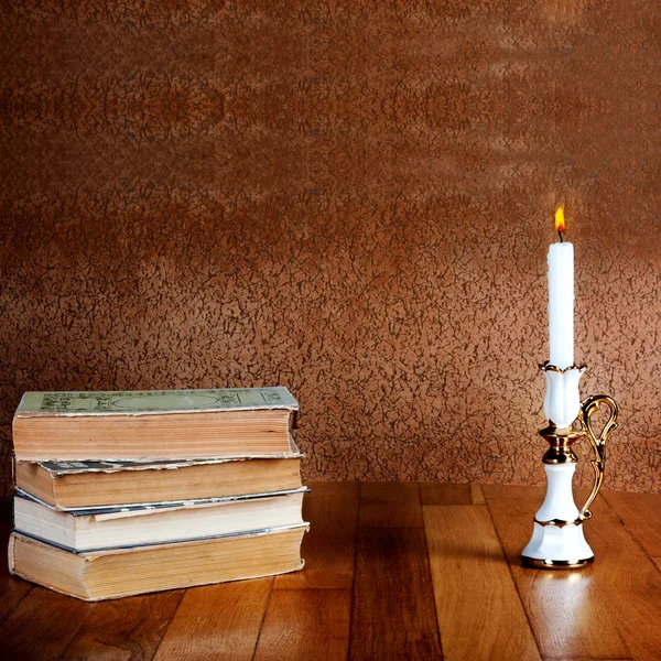 Books with candlestick and burning candle — Stock Photo, Image