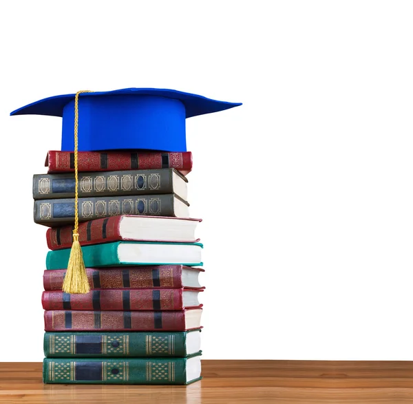 Graduation mortarboard on top of stack of books — Stock Photo, Image